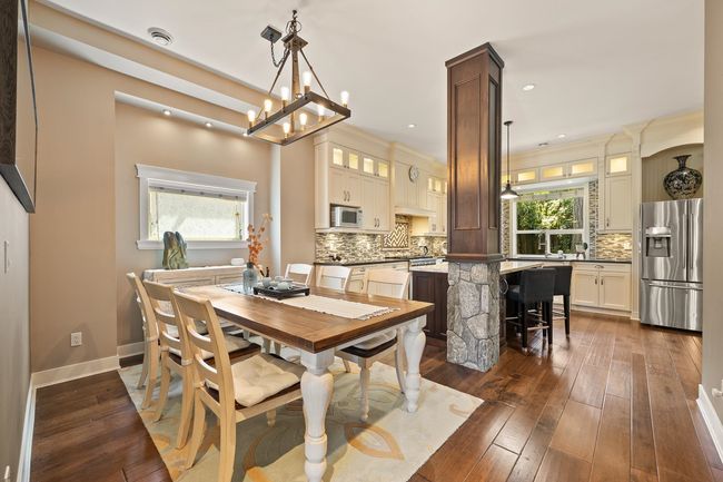 Dining space featuring dark wood-style flooring, a chandelier, and recessed lighting | Image 7