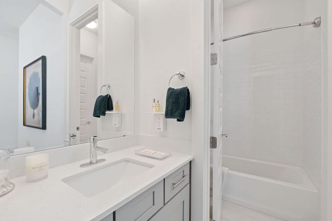 Bathroom with vanity, shower / tub combination, and tile patterned floors | Image 29