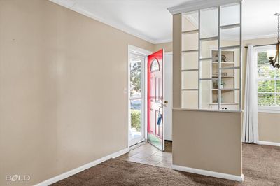 Carpeted foyer entrance with crown molding | Image 3