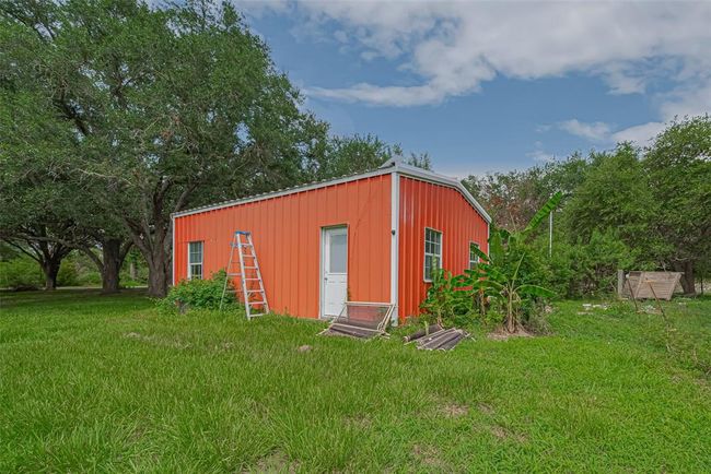 Insulated pool house run with electricity, perfect place for poolside lounging or additional entertainment space. | Image 31