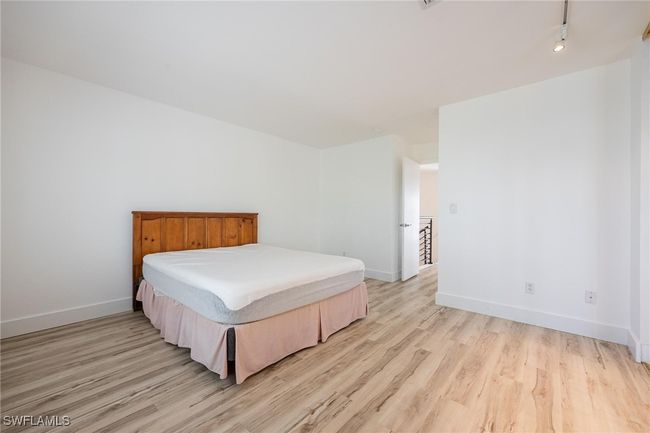 Bedroom featuring light hardwood / wood-style floors | Image 24