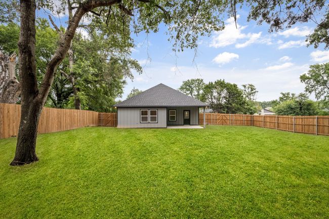 Rear view of property with a shingled roof and a patio area | Image 35