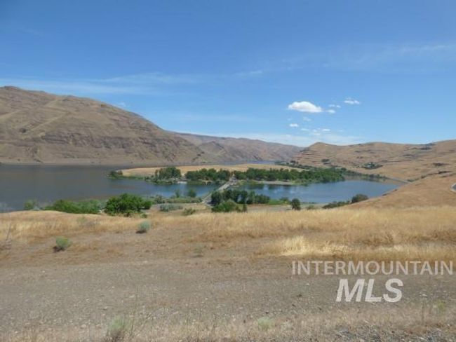 View of mountain backdrop with a large body of water | Image 19