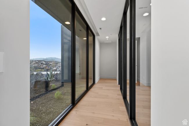 Corridor with visible vents, a mountain view, light wood finished floors, and recessed lighting | Image 19