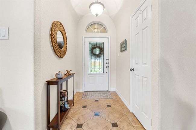 Foyer with light tile patterned floors and baseboards | Image 5