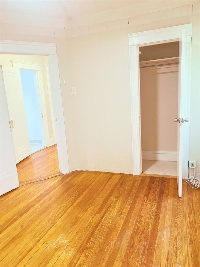 Unfurnished bedroom with light wood-style floors and a closet | Image 8