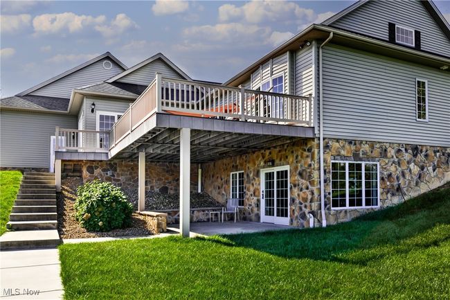 Back of property featuring stairs, a patio, a yard, and a wooden deck | Image 11