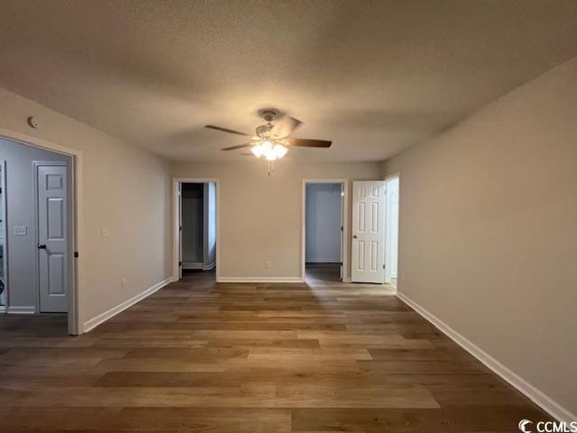 Spare room featuring baseboards, ceiling fan, and wood finished floors | Image 6