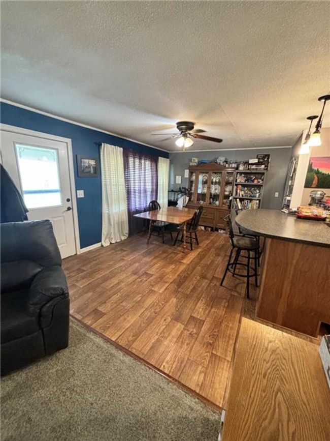 Dining area with laminate flooring and a ceiling fan | Image 17