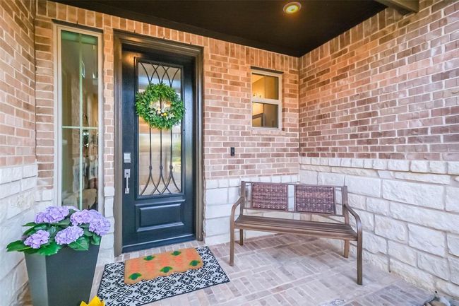Your large covered front porch is protected from the elements and provides a beautiful entrance to your home. | Image 17