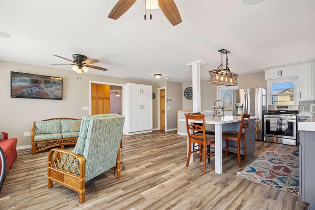 The open floor plan seamlessly connects the living room to the kitchen, where a spacious island serves as the perfect centerpiece for cooking, dining, and entertaining. | Image 4