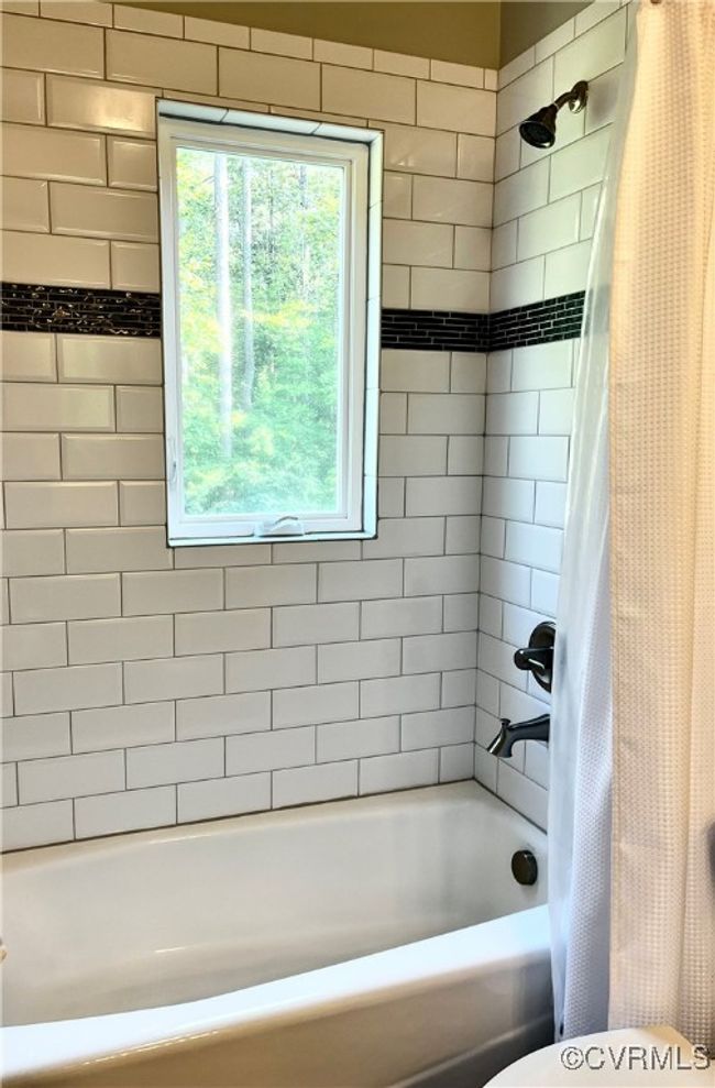 Bathroom featuring shower / tub combo with curtain | Image 22