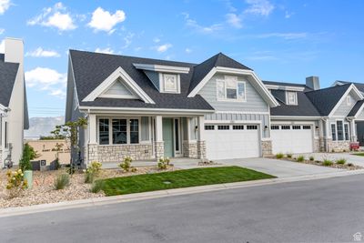 Craftsman-style home featuring a garage and covered porch | Image 2