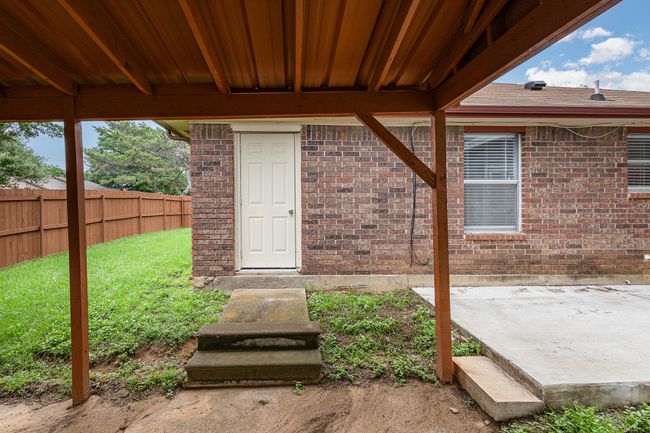 Entrance to property featuring fence and brick siding | Image 20