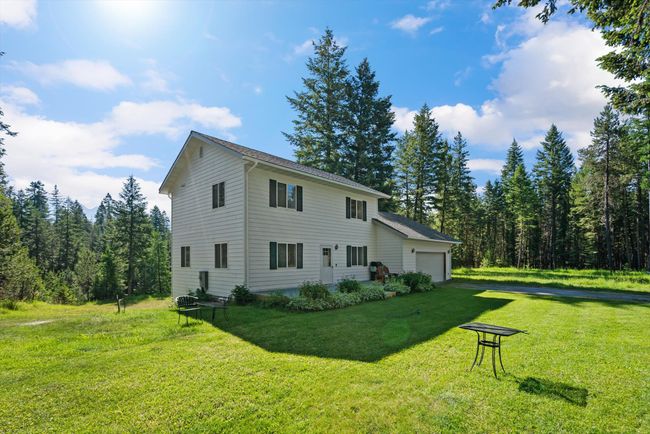 View of property exterior with a garage and a lawn | Image 4