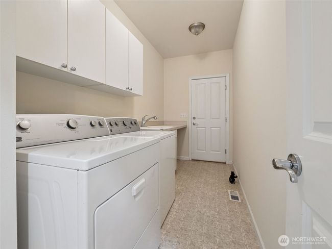 Laundry/mud room complete with sink and plenty of extra storage. Door leads out to your two car garage. | Image 24