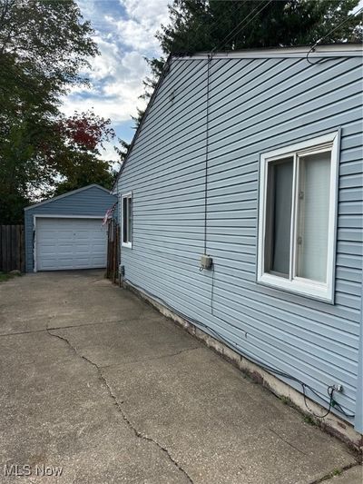 View of home's exterior with a garage | Image 2