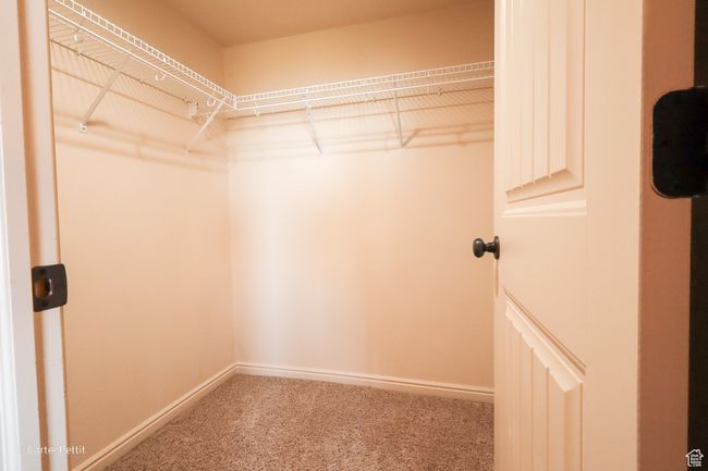 Walk in closet featuring carpet flooring | Image 16