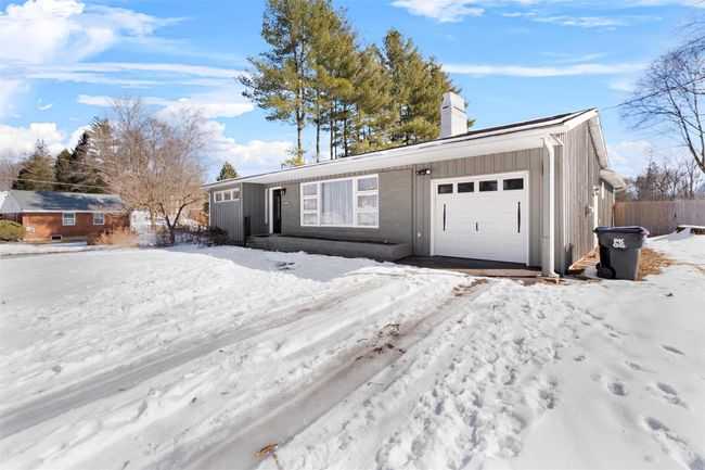 View of front of house with a chimney and an attached garage | Image 4