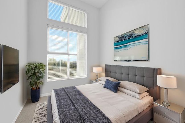 Bedroom featuring carpet floors, baseboards, and multiple windows | Image 19