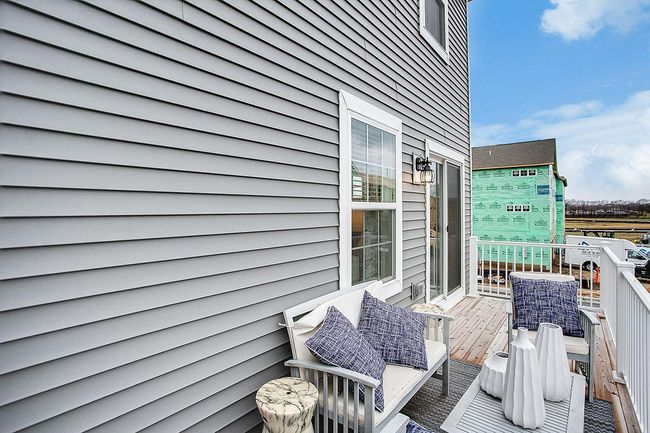Spacious deck runs the width of the home. Perfect for bringing your get together outdoors! Model picture and end unit show. Colors and finishes may vary. | Image 8
