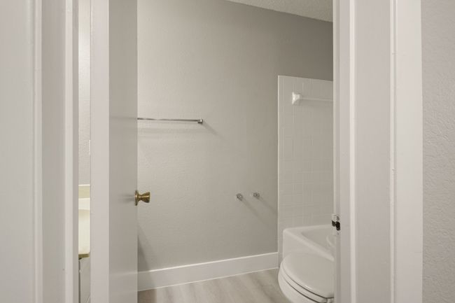 Full bathroom featuring wood finished floors and shower / bathtub combination | Image 21