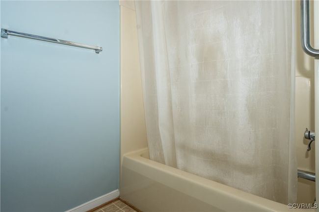 Bathroom with shower / bathtub combination with curtain and baseboards | Image 12