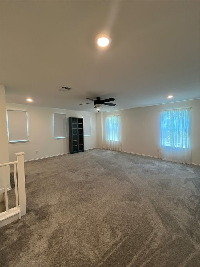 Carpeted spare room with visible vents, recessed lighting, baseboards, and ceiling fan | Image 18