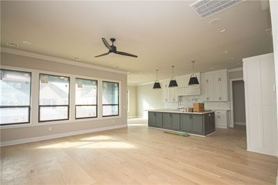 Step into the grandeur of this spacious living room featuring a tiled linear gas fireplace, perfect for cozy gatherings. | Image 2