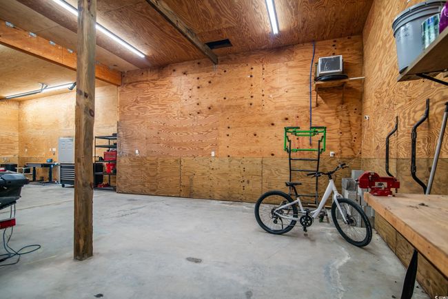 Miscellaneous room featuring concrete floors and a workshop area | Image 18