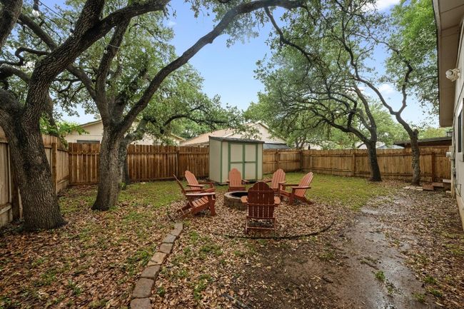 Fenced backyard with a shed and a fire pit | Image 27