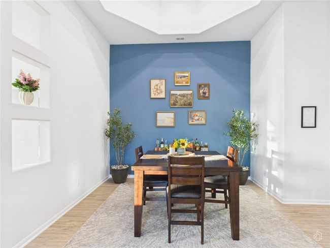 Dining space with light wood-style flooring, baseboards, and a skylight | Image 8
