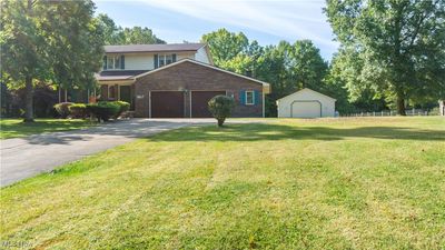 Front facade with a garage and a front lawn | Image 2