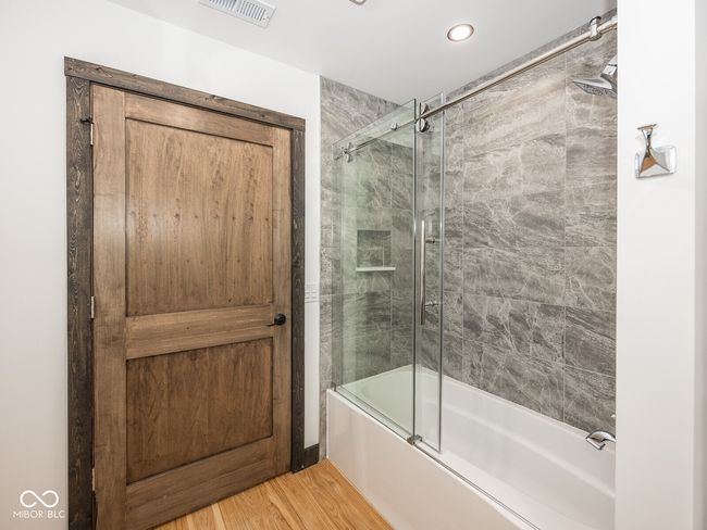 full bathroom featuring enclosed tub / shower combo, wood finished floors, and recessed lighting | Image 35