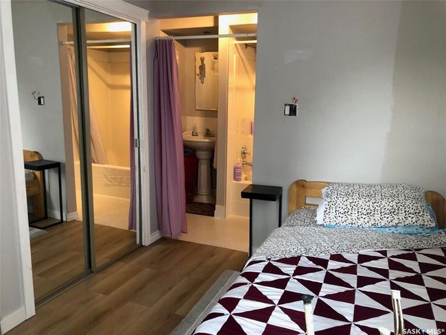 Bedroom featuring wood finished floors and a closet | Image 29