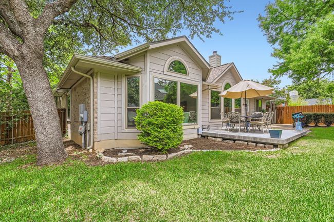 Rear view of property featuring a chimney and a patio area | Image 20