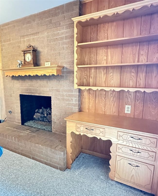 Tasteful and coordinated wood detail built-ins alongside fireplace | Image 11
