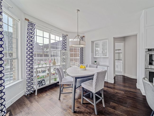 Dining space featuring baseboards and dark wood-style flooring | Image 7