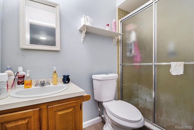 Full bathroom featuring a shower stall and vanity | Image 13