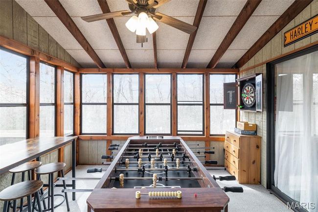 Recreation room featuring lofted ceiling with beams, carpet floors, and ceiling fan | Image 32