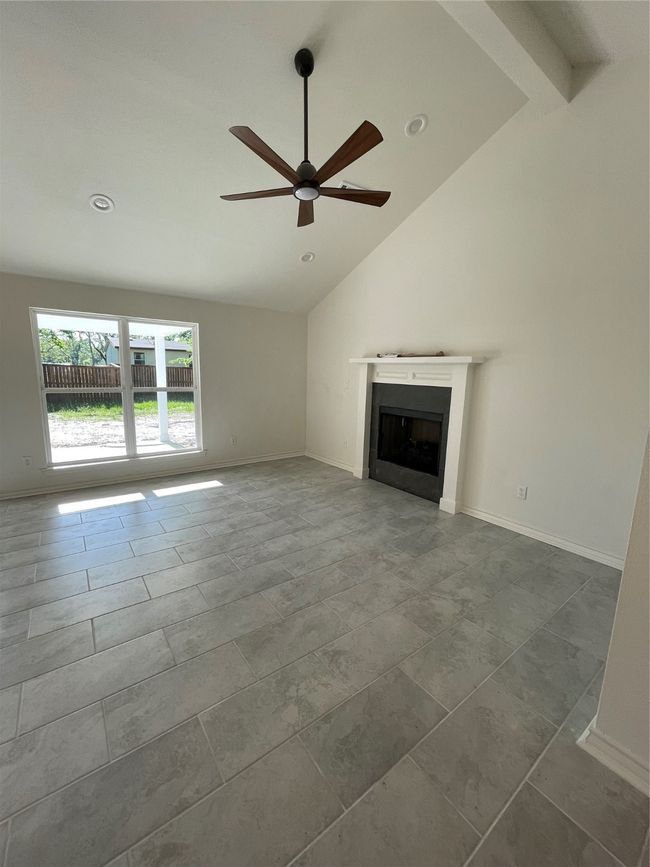 Unfurnished living room with ceiling fan, recessed lighting, baseboards, and a fireplace | Image 17