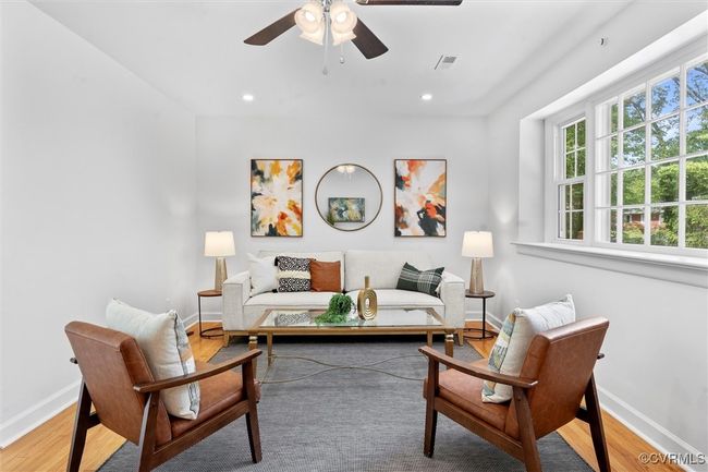 Picture window, newly refinished floors, recessed lights, and a ceiling fan | Image 5