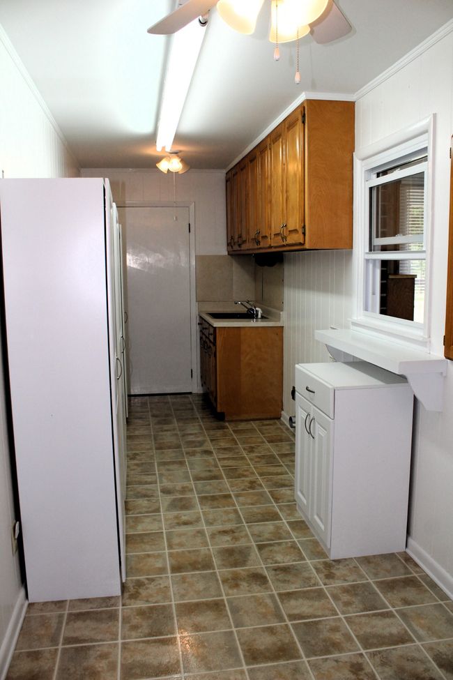 Utility room that has a walk-in pantry at the end!! | Image 21