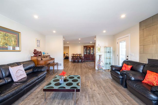 Living area with recessed lighting, wood finished floors, and visible vents | Image 5