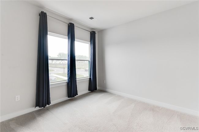 Spare room featuring light colored carpet and baseboards | Image 21