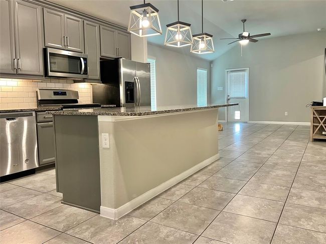 Experience culinary excellence in this gourmet kitchen featuring upgraded Whirlpool appliances. | Image 5