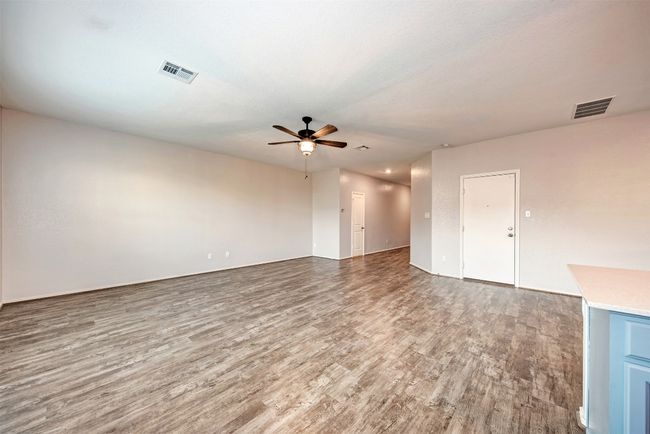 Unfurnished room featuring ceiling fan and wood finished floors | Image 8