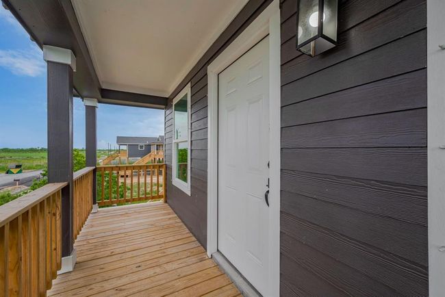 The elevated front porch provides a pleasant vantage point to take in the surrounding neighborhood and sky—perfect for relaxing outdoors. | Image 4