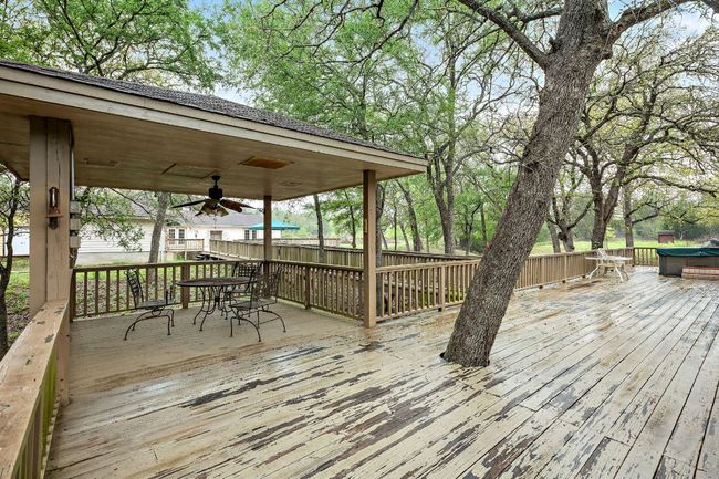 Deck featuring outdoor dining space and ceiling fan | Image 25