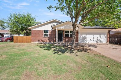 Single story home featuring a garage and a front yard | Image 2